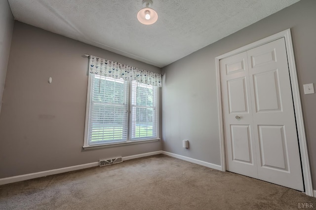 1553 Old Stage Rd, Amherst, VA 24521 - unfurnished bedroom featuring carpet floors, a textured ceiling, and a closet
