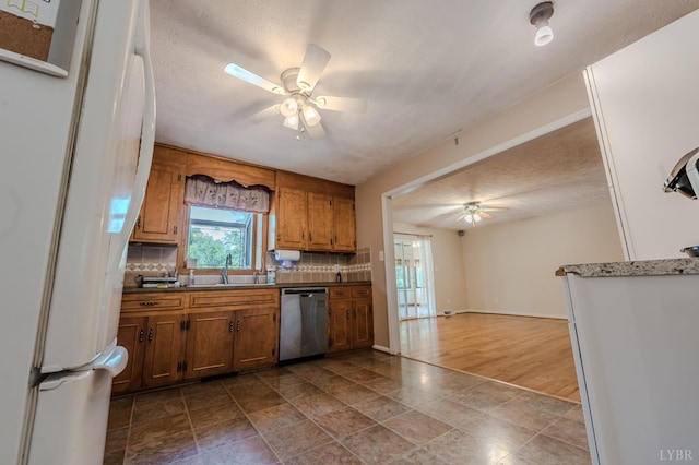1553 Old Stage Rd, Amherst, VA 24521 - kitchen with stainless steel dishwasher, a ceiling fan, freestanding refrigerator, decorative backsplash, and a textured ceiling