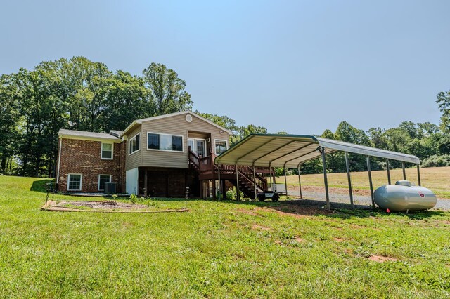 1553 Old Stage Rd, Amherst, VA 24521 - back of property featuring stairway, a carport, a yard, and brick siding