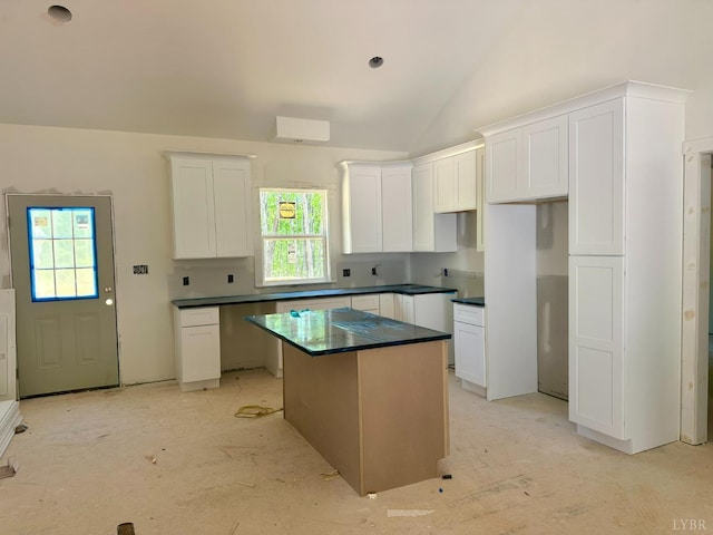 3470 Double Bridges Rd, Spout Spring, VA 24593 - kitchen with plenty of natural light, a kitchen island, white cabinets, and vaulted ceiling