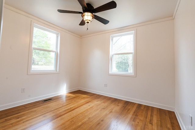 206 Caroline Ave, Brookneal, VA 24528 - empty room with healthy amount of natural light, baseboards, light wood finished floors, ornamental molding, and ceiling fan