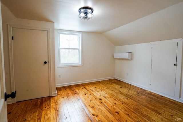 206 Caroline Ave, Brookneal, VA 24528 - additional living space featuring lofted ceiling, hardwood / wood-style floors, an AC wall unit, and baseboards