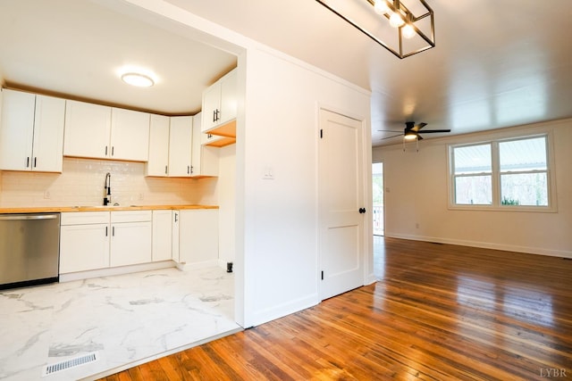 206 Caroline Ave, Brookneal, VA 24528 - kitchen with dishwasher, a sink, baseboards, and tasteful backsplash