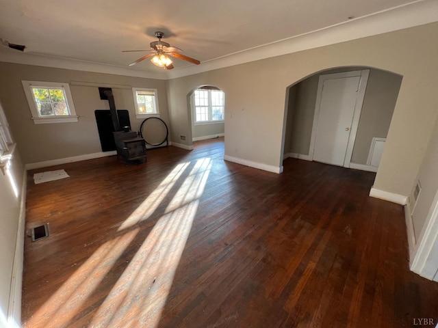 1358 S Coolwell Rd, Madison Heights, VA 24572 - unfurnished living room featuring visible vents, hardwood / wood-style floors, a wood stove, arched walkways, and plenty of natural light