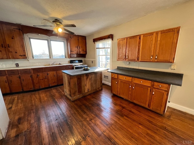 1358 S Coolwell Rd, Madison Heights, VA 24572 - kitchen featuring white electric range oven, brown cabinets, dark wood-style flooring, and a sink