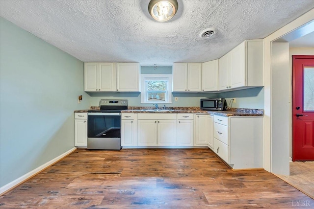 3554 Leffel Rd, Roanoke, VA 24018 - kitchen with appliances with stainless steel finishes, a sink, dark countertops, dark wood-style flooring, and a textured ceiling