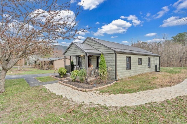 3554 Leffel Rd, Roanoke, VA 24018 - view of side of home with a porch, a yard, and metal roof