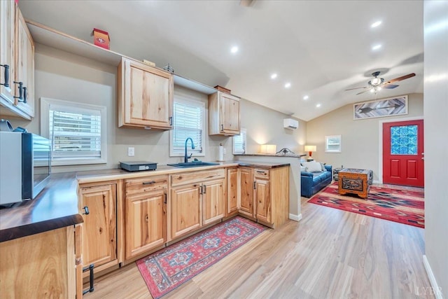 3554 Leffel Rd, Roanoke, VA 24018 - kitchen featuring a sink, stainless steel microwave, light brown cabinetry, a peninsula, and light wood finished floors