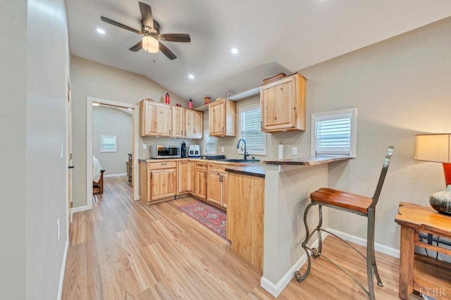 3554 Leffel Rd, Roanoke, VA 24018 - kitchen featuring light brown cabinets, stainless steel microwave, light wood finished floors, vaulted ceiling, and recessed lighting