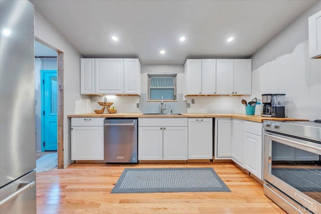 3554 Leffel Rd, Roanoke, VA 24018 - kitchen with stainless steel appliances, a sink, white cabinets, and recessed lighting