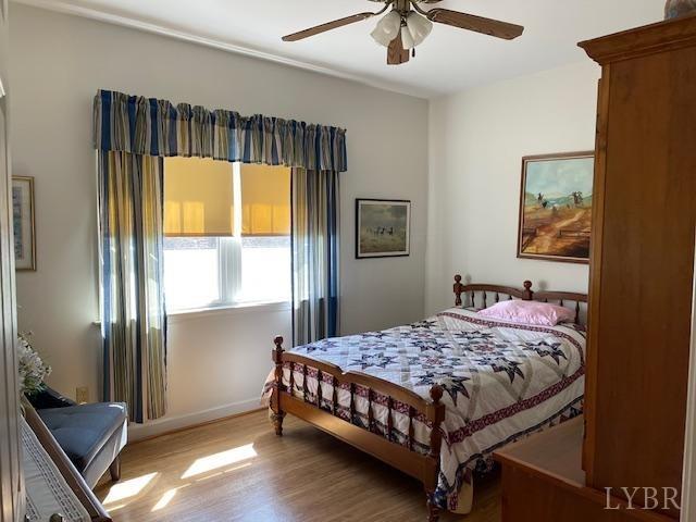 1534 Main St, Altavista, VA 24517 - bedroom with baseboards, ceiling fan, and wood finished floors