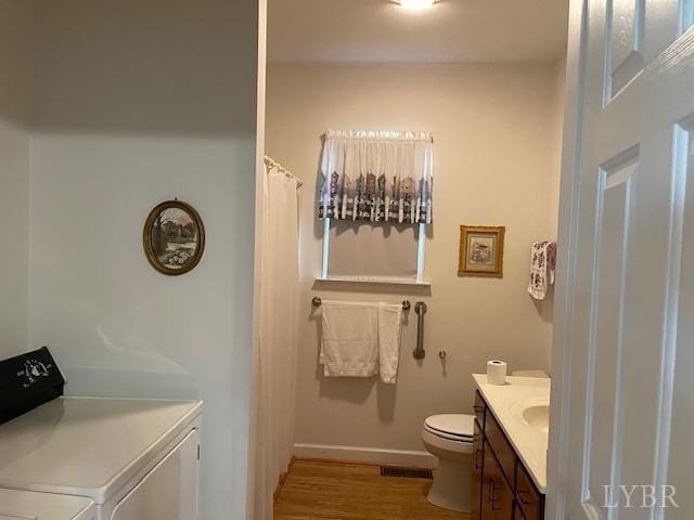 1534 Main St, Altavista, VA 24517 - full bath featuring vanity, visible vents, toilet, wood finished floors, and washer and dryer