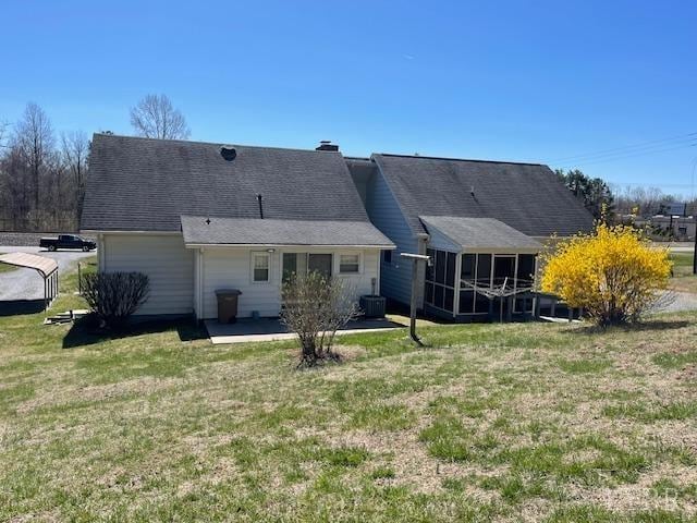 1534 Main St, Altavista, VA 24517 - back of house with central AC unit, a sunroom, a yard, a chimney, and a patio