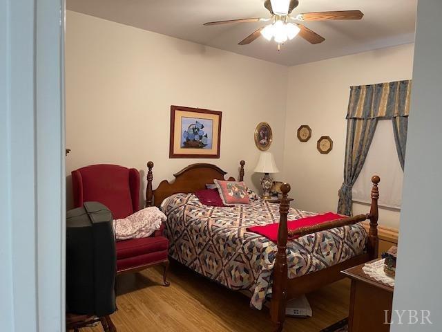 1534 Main St, Altavista, VA 24517 - bedroom with a ceiling fan and wood finished floors