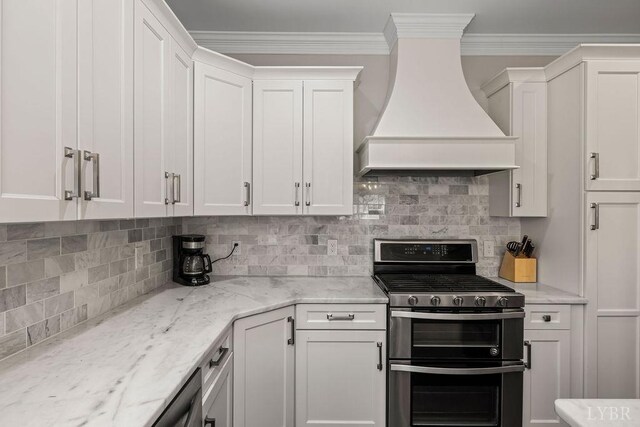 1055 Tori Ct, Forest, VA 24551 - kitchen featuring range with two ovens, premium range hood, white cabinets, tasteful backsplash, and crown molding