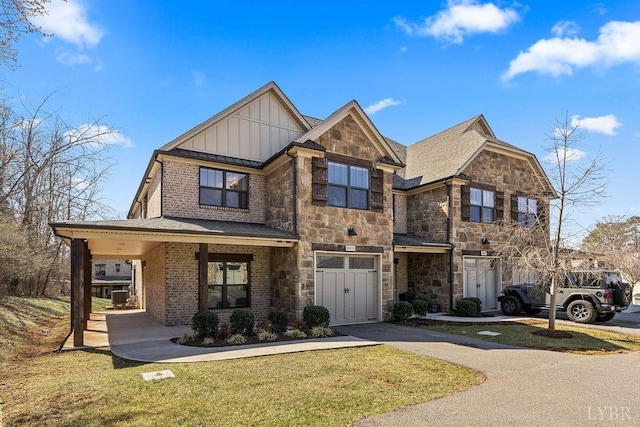 1055 Tori Ct, Forest, VA 24551 - view of front of property with board and batten siding, stone siding, and a front yard