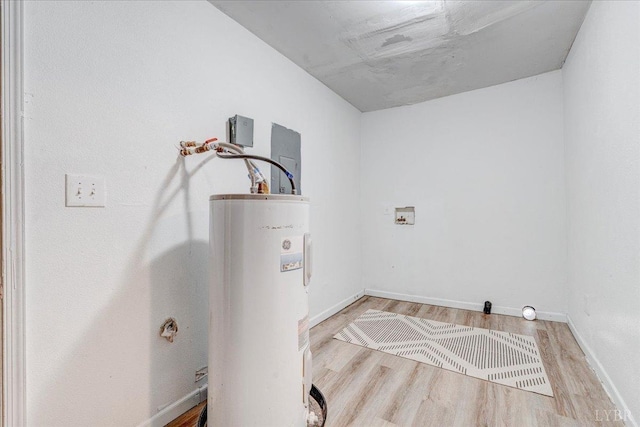 111 Willow St, Lynchburg, VA 24503 - laundry area featuring baseboards, laundry area, water heater, and wood finished floors