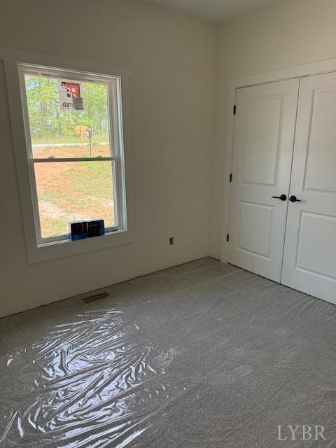 2116 Lime Plant Rd, Appomattox, VA 24522 - unfurnished bedroom with multiple windows and a closet