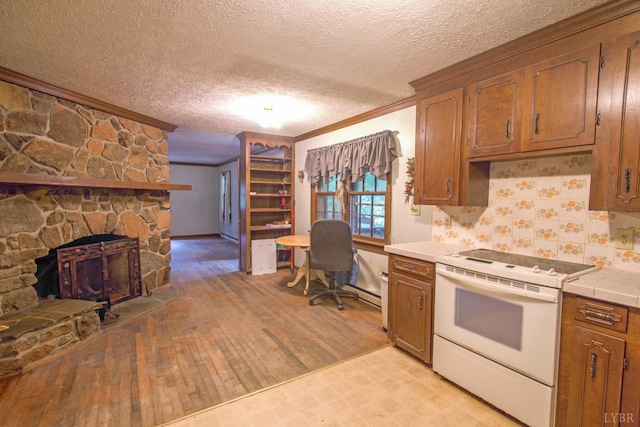 3510 Bear Creek Rd, Rustburg, VA 24588 - kitchen featuring white electric range oven, ornamental molding, light wood-style flooring, tile counters, and a textured ceiling