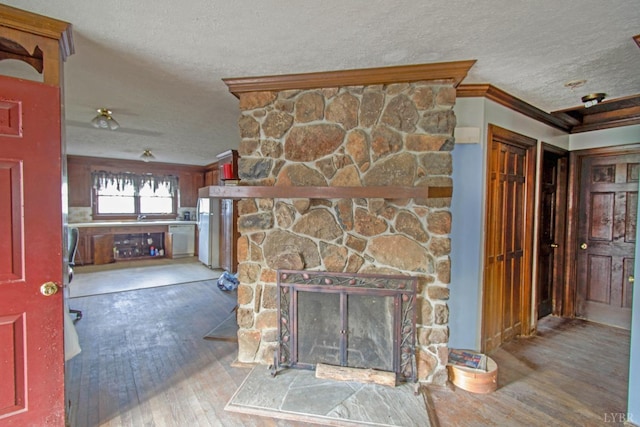 3510 Bear Creek Rd, Rustburg, VA 24588 - unfurnished living room with a sink, hardwood / wood-style flooring, a textured ceiling, crown molding, and a stone fireplace