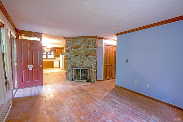 3510 Bear Creek Rd, Rustburg, VA 24588 - unfurnished living room featuring crown molding, wood-type flooring, a textured ceiling, a stone fireplace, and a baseboard radiator