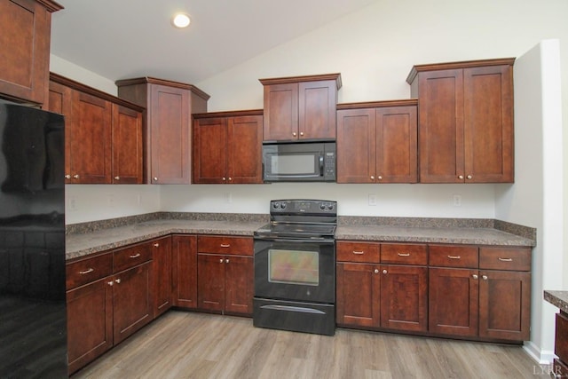 268 Oak Spring Ln, Madison Heights, VA 24572 - kitchen featuring black appliances, dark countertops, light wood finished floors, vaulted ceiling, and recessed lighting