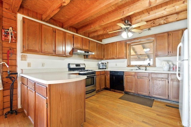 kitchen with a sink, freestanding refrigerator, dishwasher, under cabinet range hood, and gas stove