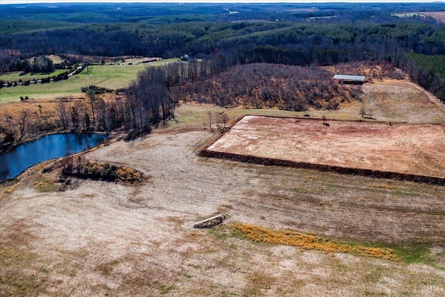 aerial view with a water view and a forest view