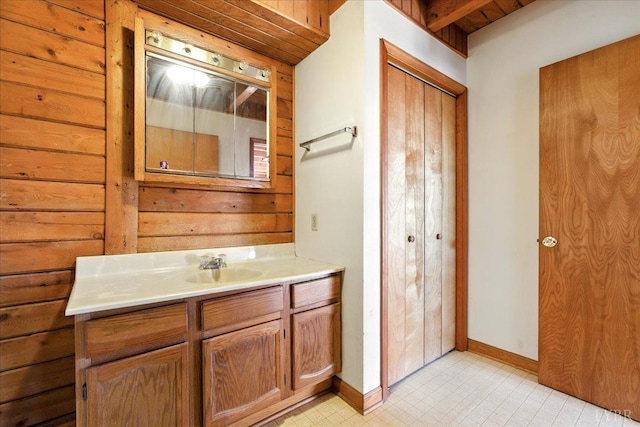 bathroom featuring tile patterned floors, vanity, and baseboards