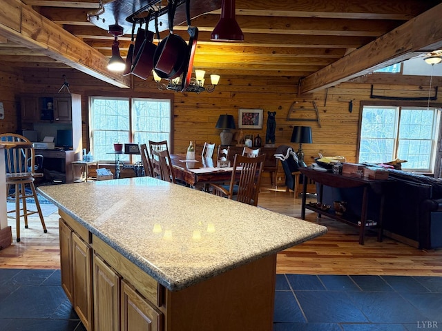 1228 Rosser Mill Rd, Pamplin, VA 23958 - kitchen featuring wooden walls, open floor plan, light countertops, a center island, and beamed ceiling