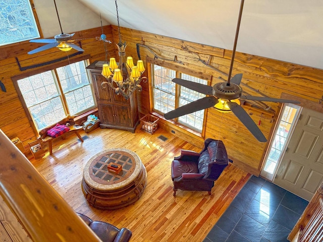 1228 Rosser Mill Rd, Pamplin, VA 23958 - living room featuring wooden walls, a ceiling fan, plenty of natural light, a chandelier, and wood finished floors
