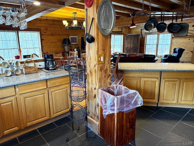 1228 Rosser Mill Rd, Pamplin, VA 23958 - kitchen with wooden walls, a chandelier, beamed ceiling, and dark tile patterned floors