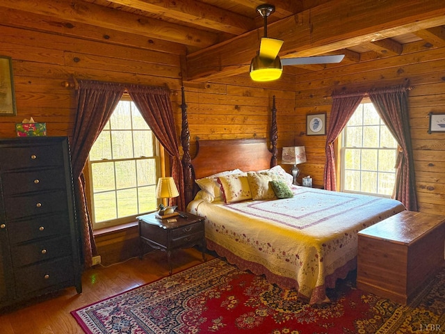 1228 Rosser Mill Rd, Pamplin, VA 23958 - bedroom featuring beamed ceiling, wooden walls, and wood finished floors