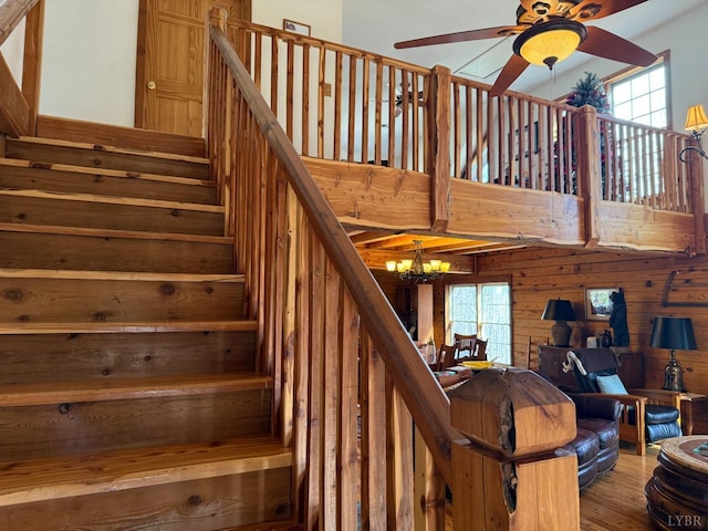 1228 Rosser Mill Rd, Pamplin, VA 23958 - stairway with a ceiling fan, wood finished floors, a chandelier, a high ceiling, and wooden walls