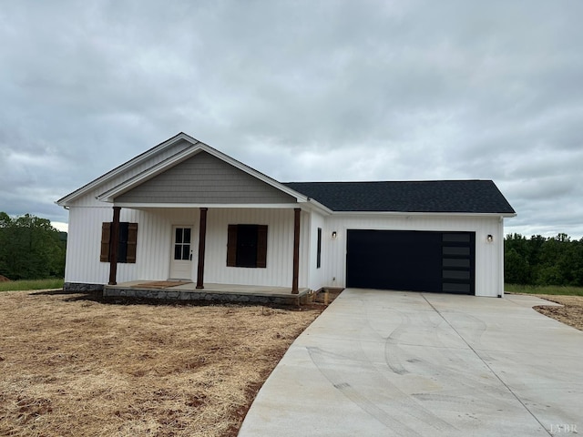 9866 Leesville Rd, Evington, VA 24550 - modern farmhouse with a porch, a garage, driveway, and roof with shingles