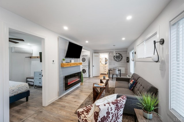 326 Jackson St, Lynchburg, VA 24504 - living area featuring recessed lighting, a wall unit AC, a glass covered fireplace, stacked washer and dryer, and light wood-style floors