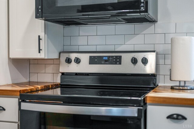 326 Jackson St, Lynchburg, VA 24504 - room details featuring backsplash, black microwave, white cabinets, and electric range