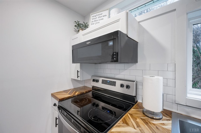 326 Jackson St, Lynchburg, VA 24504 - kitchen with white cabinetry, stainless steel range with electric stovetop, tasteful backsplash, and black microwave