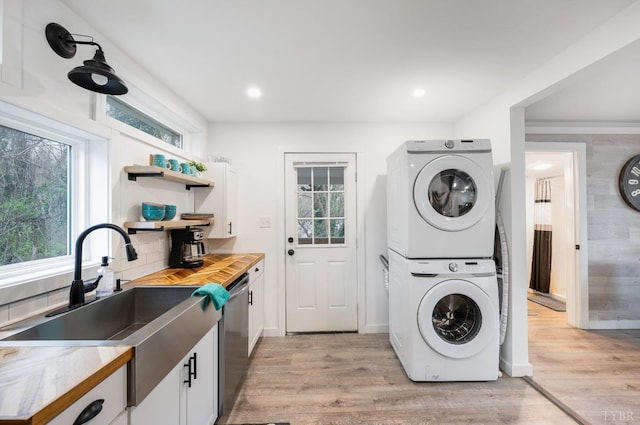 326 Jackson St, Lynchburg, VA 24504 - washroom featuring a wealth of natural light, light wood finished floors, stacked washer / dryer, and a sink