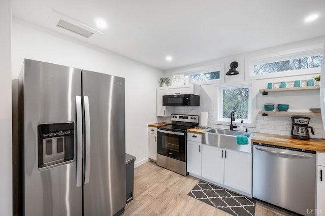 326 Jackson St, Lynchburg, VA 24504 - kitchen featuring a sink, wood counters, white cabinetry, backsplash, and appliances with stainless steel finishes