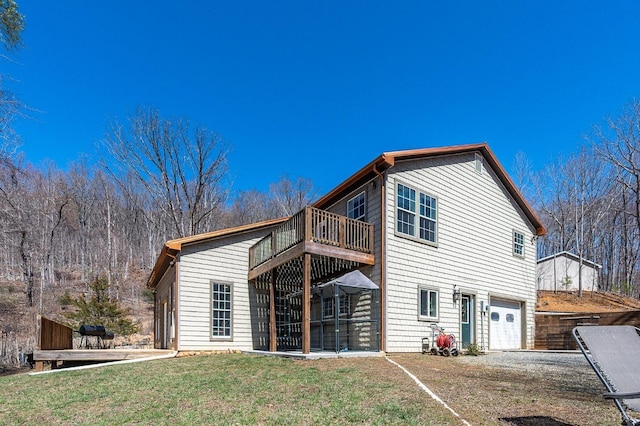 700 Cloudcroft Dr, Monroe, VA 24574 - rear view of house with gravel driveway, a deck, a yard, and an attached garage