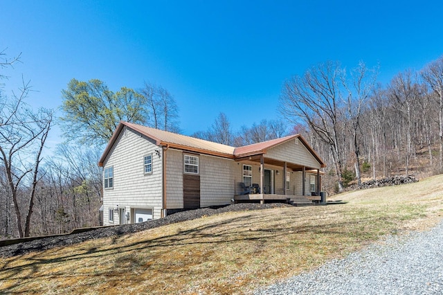 700 Cloudcroft Dr, Monroe, VA 24574 - view of side of home with a lawn, metal roof, a porch, and an attached garage