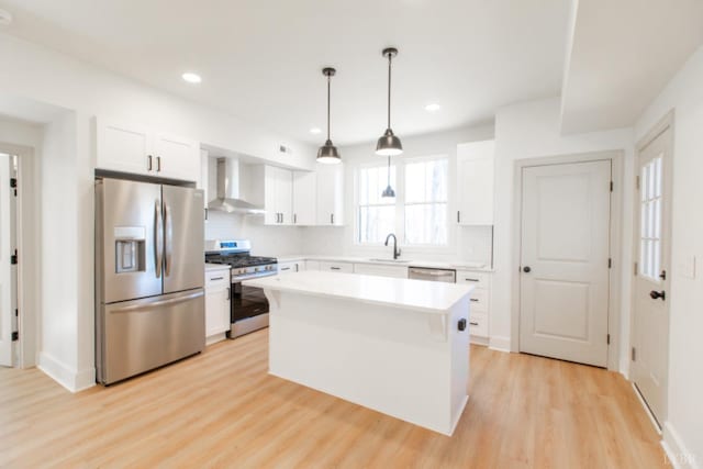 271 Riverside Dr, Lynchburg, VA 24503 - kitchen featuring stainless steel appliances, wall chimney exhaust hood, light wood finished floors, white cabinets, and light countertops