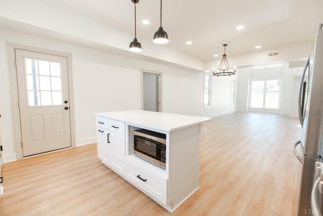 271 Riverside Dr, Lynchburg, VA 24503 - kitchen with stainless steel appliances, light wood-type flooring, white cabinets, hanging light fixtures, and recessed lighting