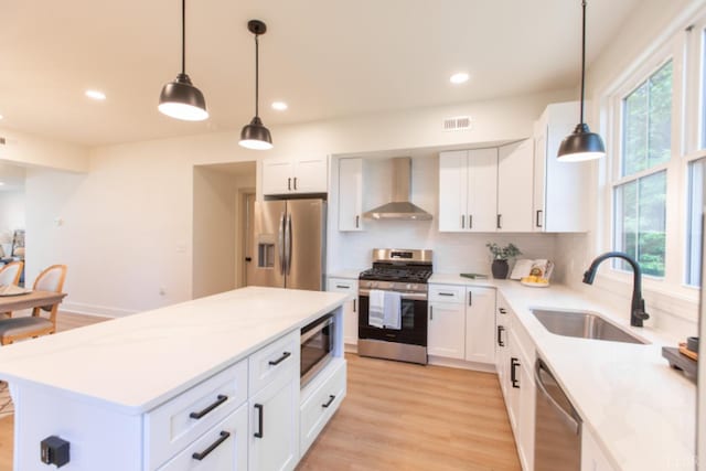 271 Riverside Dr, Lynchburg, VA 24503 - kitchen with wall chimney range hood, appliances with stainless steel finishes, light countertops, recessed lighting, and white cabinets