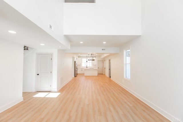 271 Riverside Dr, Lynchburg, VA 24503 - unfurnished living room with a chandelier, light wood-style floors, recessed lighting, and a towering ceiling