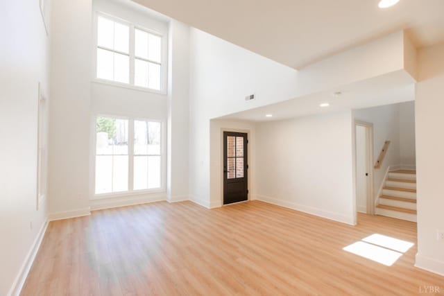271 Riverside Dr, Lynchburg, VA 24503 - unfurnished living room with light wood finished floors, stairway, recessed lighting, and a high ceiling