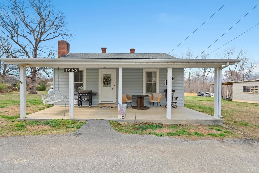 1465 Wheatland Rd, Bedford, VA 24523 - view of front of property with a porch, a chimney, and a front yard