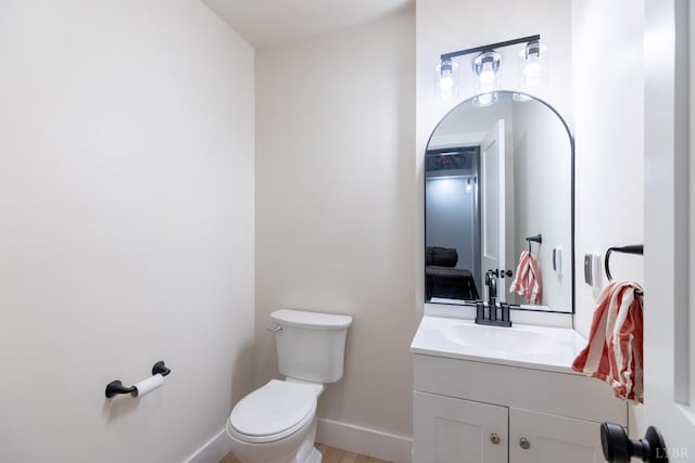 355 Camellia, Hurt, VA 24563 - half bathroom with baseboards, wood finished floors, toilet, and vanity