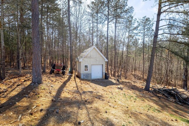 355 Camellia, Hurt, VA 24563 - view of yard with a detached garage, an outbuilding, and a forest view